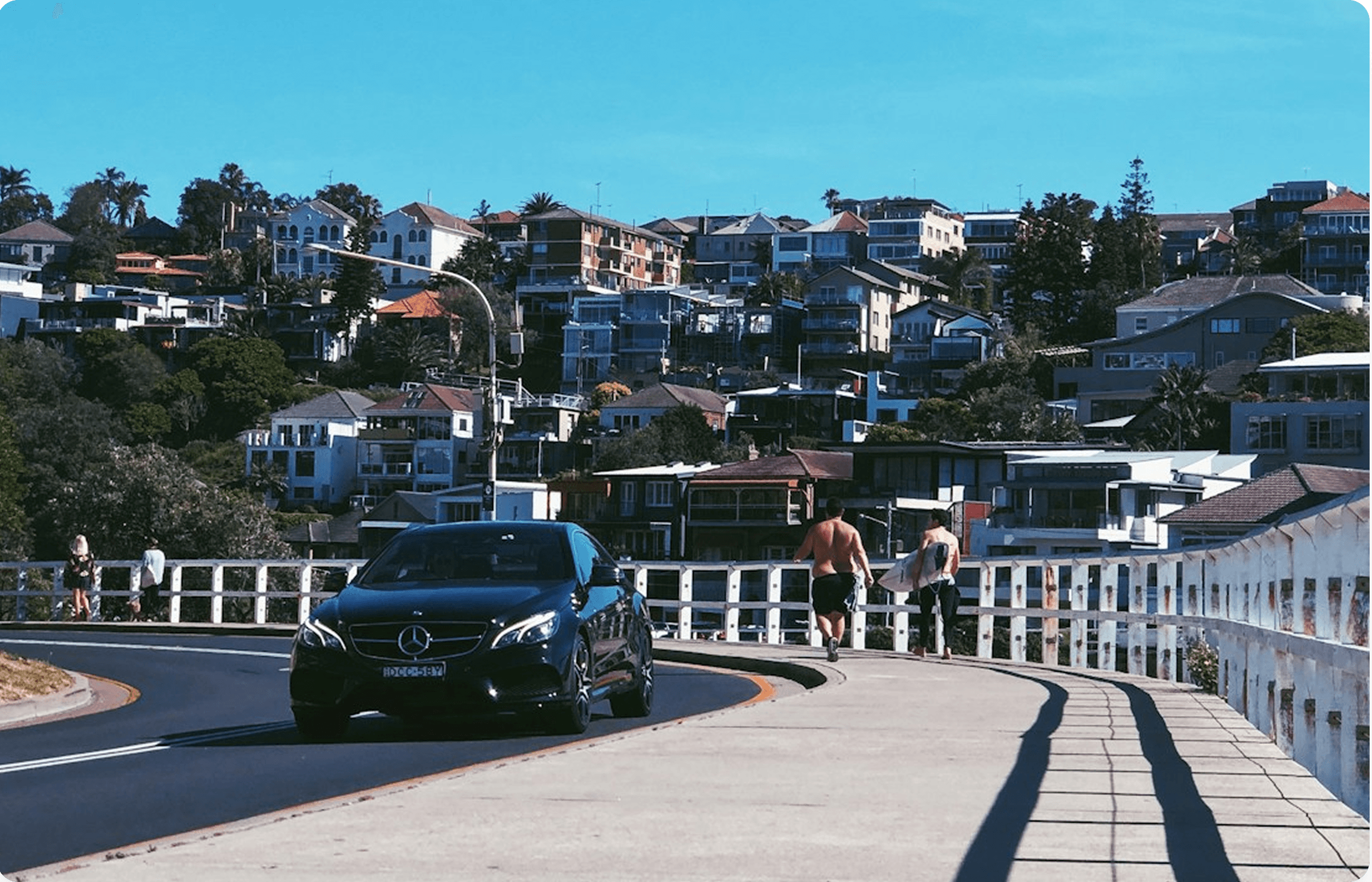 OKTaxis chauffeur service car driving across a bridge